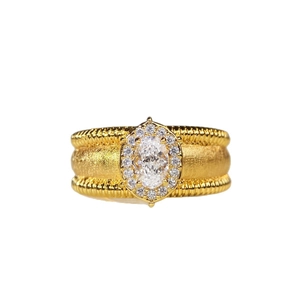 Golden halo ring featuring an oval centerpiece gemstone and textured brushed metal band