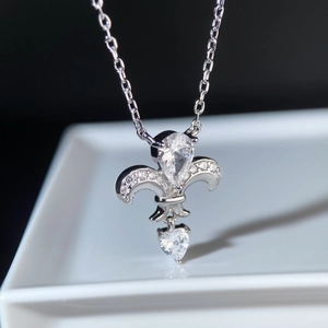 Close-up of silver Iris pendant with pear-cut crystal and sparkling heart stone