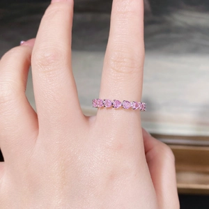 Detailed macro view of 925 sterling silver eternity ring with pink heart shaped zircons