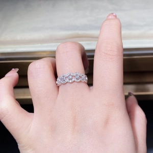 Macro view of S925 sterling silver lace ring with zircon pavé on a model's finger