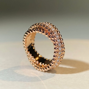 Elegant rose gold beaded crossover ring featuring a row of sparkling cubic zirconia