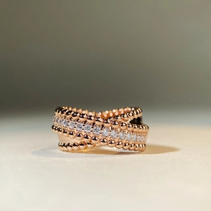 Crossed rose gold beaded ring with rows of sparkling zircon stones for a layered look