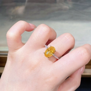 Close-up of S925 silver ring featuring an 8x12mm yellow oval gemstone with four-prong setting