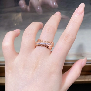 Detail of rose gold beaded ring with sparkling pavé cubic zirconia gemstones on hand