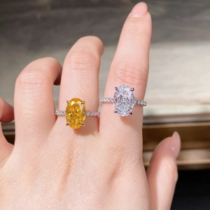 Close-up of S925 silver rings featuring oval cut yellow and clear five carat stones
