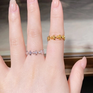 Close-up of gold and silver S925 rings with vintage fleur-de-lis hollow floral pattern