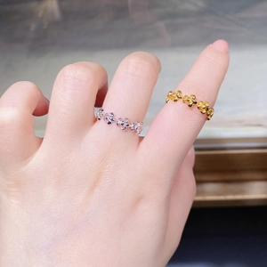 Close-up of vintage floral S925 silver rings in gold and silver finish on hand
