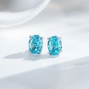 Classic S925 sterling silver stud earrings with oval-cut light blue gemstones and 4-prong setting