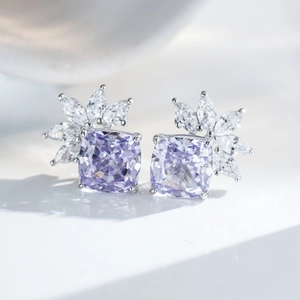 Macro detail of S925 sterling silver stud earrings with cushion-cut purple gemstones