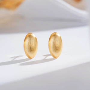 Handcrafted brushed 24K gold-plated oval stud earrings with minimalist matte finish texture