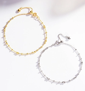 Detail of S925 silver beaded bracelets featuring heart pendants and adjustable chains