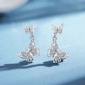 S925 sterling silver hollow butterfly earrings with dual-layer filigree drop design