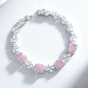 Macro detail of S925 silver bracelet featuring pink cushion-cut gems and pear diamonds