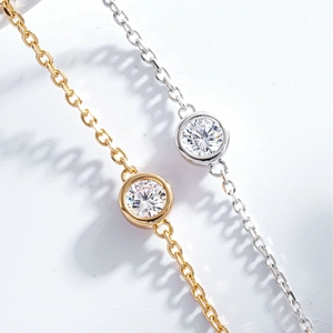 Detail of S925 silver bubble bracelets in gold and silver finish with bezel-set cubic zirconia