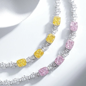 Macro shot of cushion-cut yellow and pink gems with marquise diamonds on silver bracelet