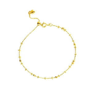 Adjustable golden link bracelet with faceted beads and a heart-shaped charm on white background
