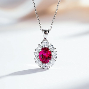 Macro shot of S925 silver flower pendant with oval ruby gemstone and brilliant white zircons
