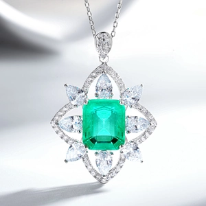 Macro shot of silver Halo emerald cut green gemstone pendant with zircon accents