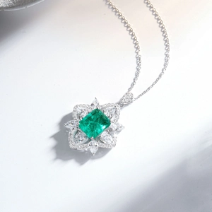 Detail of S925 silver necklace with emerald-cut green stone and sparkling cubic zirconia