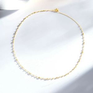 Detailed view of S925 sterling silver chain with 24K gold plated beads and spring clasp