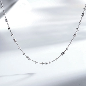 Macro shot of S925 sterling silver chain featuring faceted beads and tiny star charms