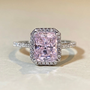 Elegant Radiant cut pink diamond halo ring in S925 sterling silver on textured background