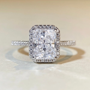 Macro shot of Radiant cut halo engagement ring with pavé set band in S925 silver
