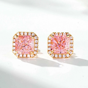 Detailed macro view of square pink radiant cut silver earrings with halo diamond setting