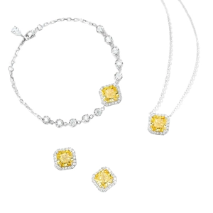 Macro detail of silver jewelry set featuring yellow cushion-cut gemstones with halo setting