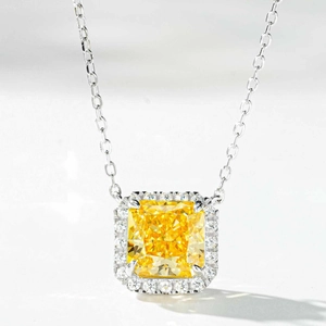 Macro view of a square-cut yellow gemstone pendant surrounded by white crystals