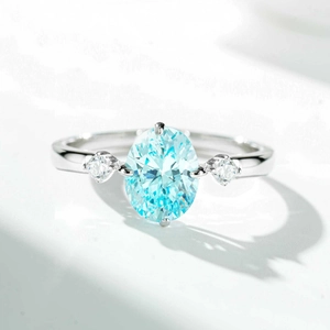 Macro shot of an oval light blue gemstone ring with symmetrical side diamonds