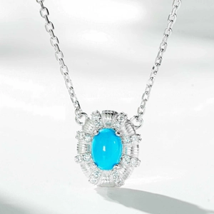 Macro shot of 925 sterling silver necklace with oval turquoise stone and diamond halo