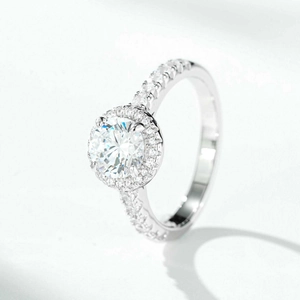 Macro detail of 1 carat round moissanite ring with halo setting and pave diamond band