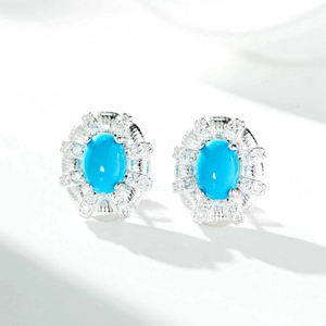 Close-up of S925 silver oval turquoise stud earrings with halo diamond settings