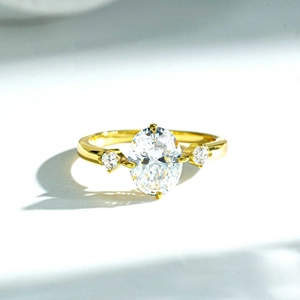Classic 18K gold plated 925 silver ring featuring three oval and round clear gemstones