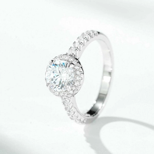 Classic 1 carat round moissanite halo ring in silver with pavé diamond band