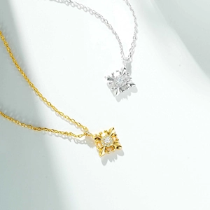 Detailed view of silver and gold vintage cross star pendants with sparkling crystal inlay