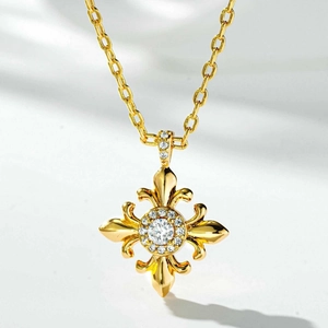 Gold fleur-de-lis cross necklace with a large crystal center and zircon accents