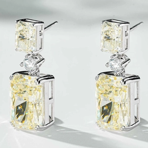 Macro detail of S925 silver drop earrings featuring radiant cut yellow carbon diamonds