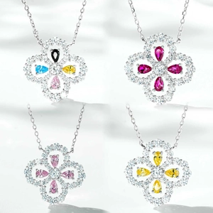 Detailed close-up of four-leaf clover pendants with colorful gemstones and diamonds