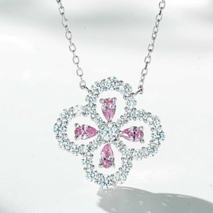 Macro view of clover pendant with pink teardrop stones and white zircon pavé setting