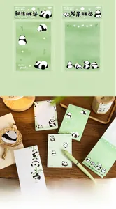 Detail view of cute panda themed sticky notes with rolling panda design on wooden table