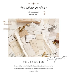 Macro view of vintage style sticky notes with retro ticket designs on a tray