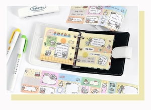 Detailed view of mini 3-hole binder with black and white leather texture and stickers
