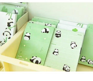 Close-up of cute panda memo pads with bamboo designs in a yellow storage box
