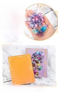 Detailed macro of large laser PET flower stickers with purple floral petal patterns