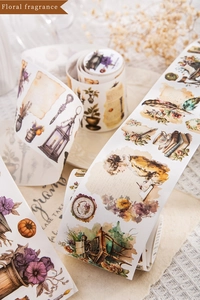 Close-up of vintage washi tape with hand-drawn illustrations of girls, flowers and lamps