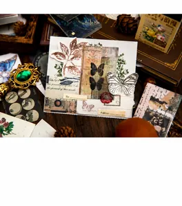 Flat lay of vintage collage scrapbooking material with butterflies and leaf motifs
