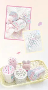 Detail showing macaron-colored washi tape with handwritten letters and die-cut patterns