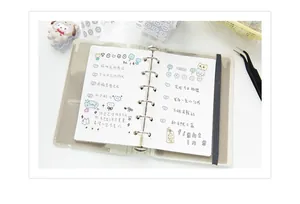 Detail of a 6-ring binder notebook with frosted cover, dot grid pages, and elastic closure strap
